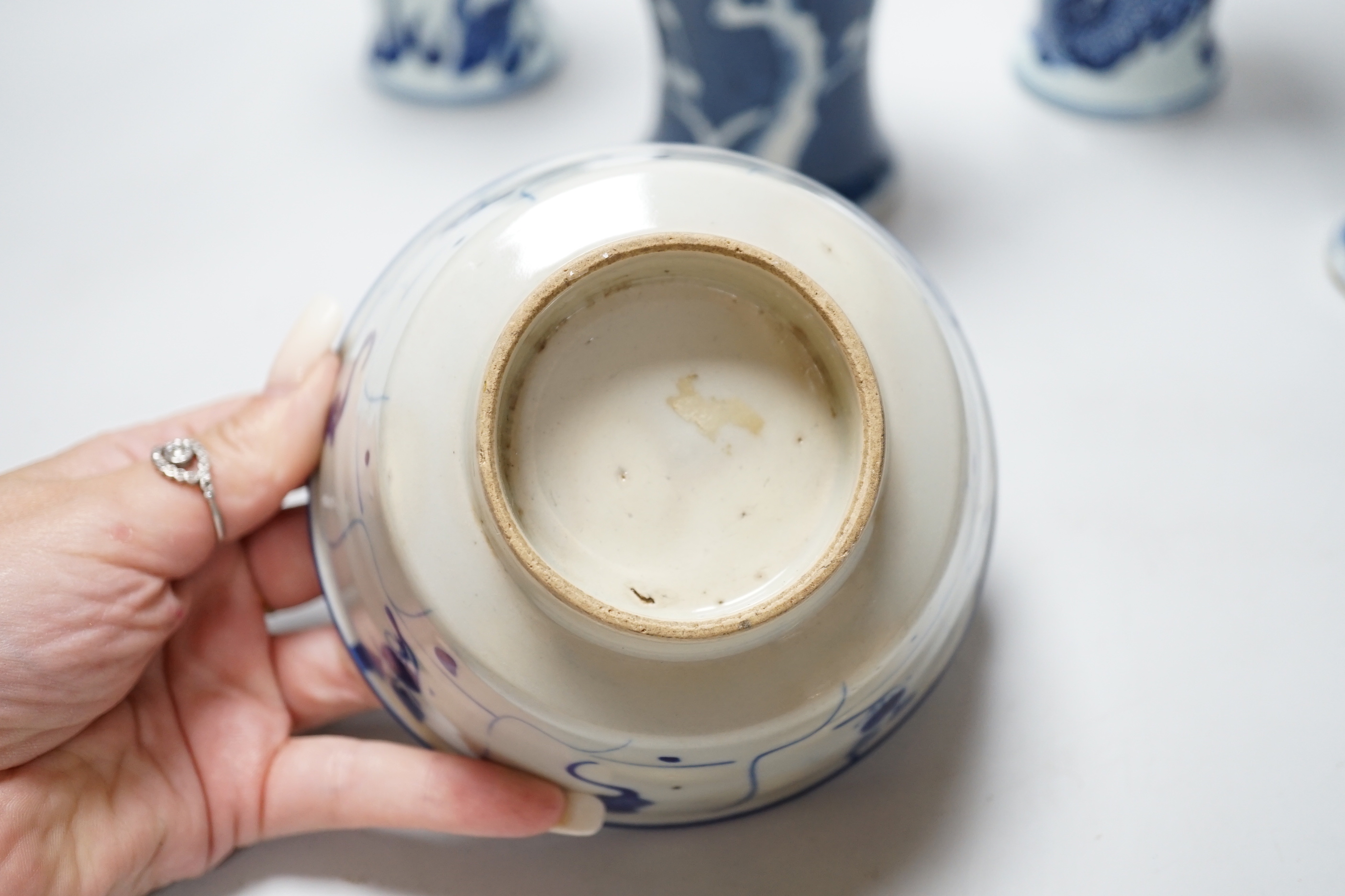 A group of Chinese blue and white ceramics including two prunus flower vases and three bowls, the largest 26cm in diameter